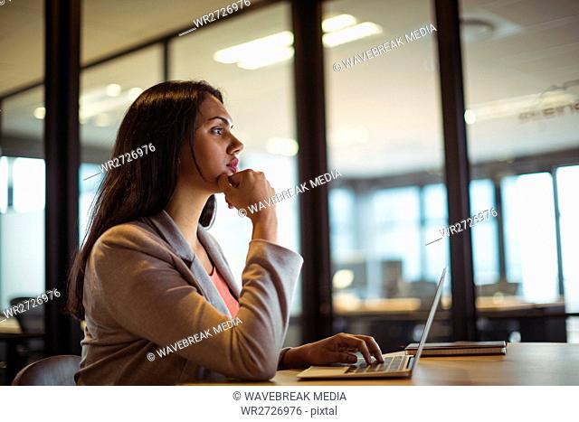 Businesswoman working over laptop