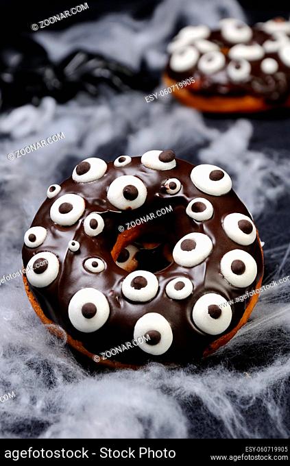 Donuts with chocolate icing decorated googly eyes on Halloween