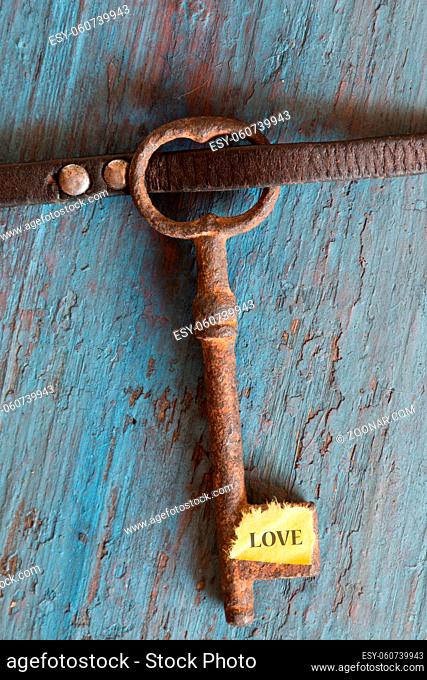 Key with the heart as a symbol of love. Vintage card with old key