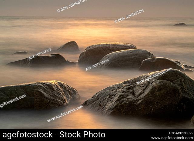 Rocky coastline and surf at sunset, Gros Morne National Park, Newfoundland and Labrador NL, Canada