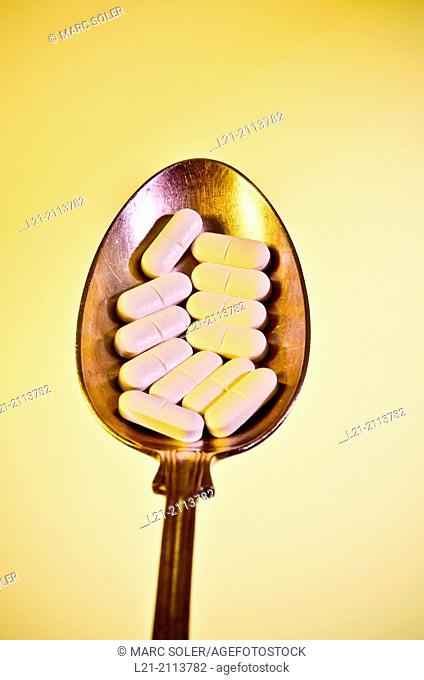 White pills on spoon