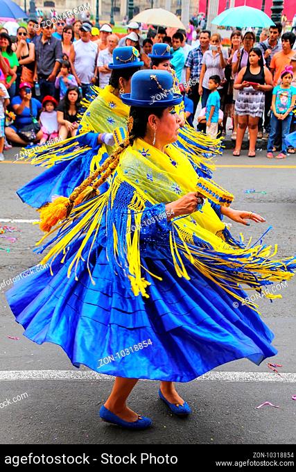 Local women dancing during Festival of the Virgin de la Candelaria in Lima, Peru. The core of the festival is dancing and music performed by different dance...