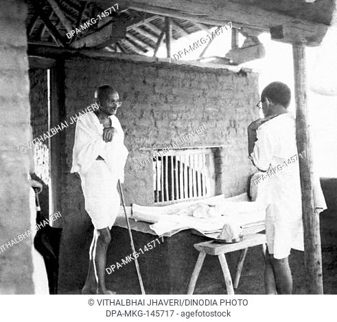 Mahatma Gandhi talking with J C Kumarappa at Sevagram Ashram , 1940 , Abha Gandhi , Mahatma Gandhi , fondling a young calf at Sevagram Ashram , 1940