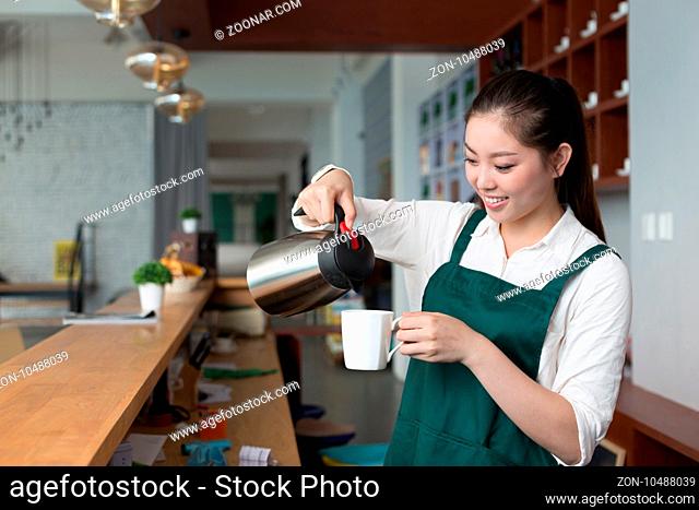 young beautiful woman works near counter in cafe