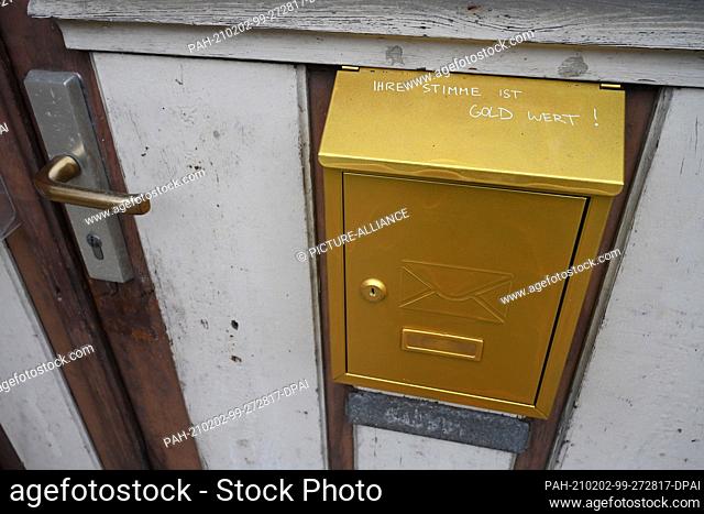 01 February 2021, Mecklenburg-Western Pomerania, Loitz: On a letterbox you can see the writing ""Your vote is worth God !"" in the city center of Loitz in the...