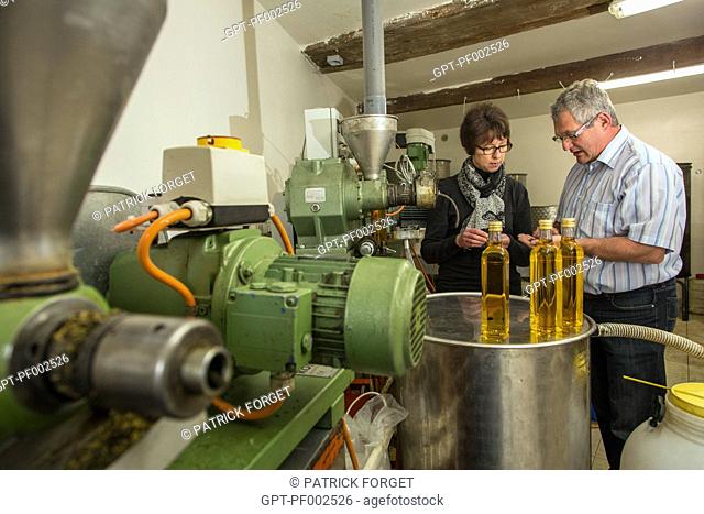 NATHALIE DE WEVER, SHOP OWNER AND MEMBER OF THE LOCAVORE MOVEMENT, TASTING THE OIL MADE BY JEAN-MARIE LENFANT, PRODUCER OF RAPESEED AND SUNFLOWER SEED OIL