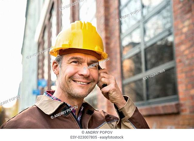 Builder Wearing Hardhat Talking On Walkie Talkie