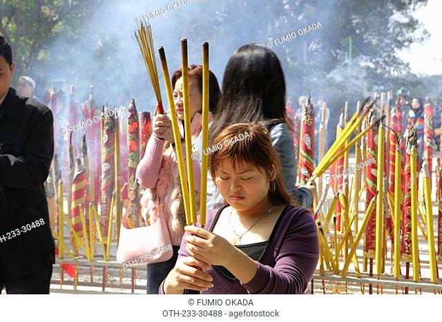 Worshippers offering incense at Po Lin Monastery, Lantau Island, Hong Kong