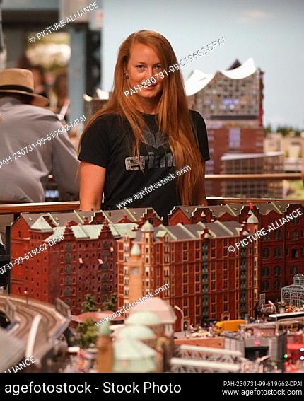 PRODUCTION - 18 July 2023, Hamburg: Model maker Tanja Schlabitz stands behind the old Speicherstadt in Miniatur Wunderland