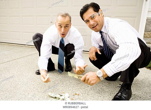 Two businessmen gambling on the street