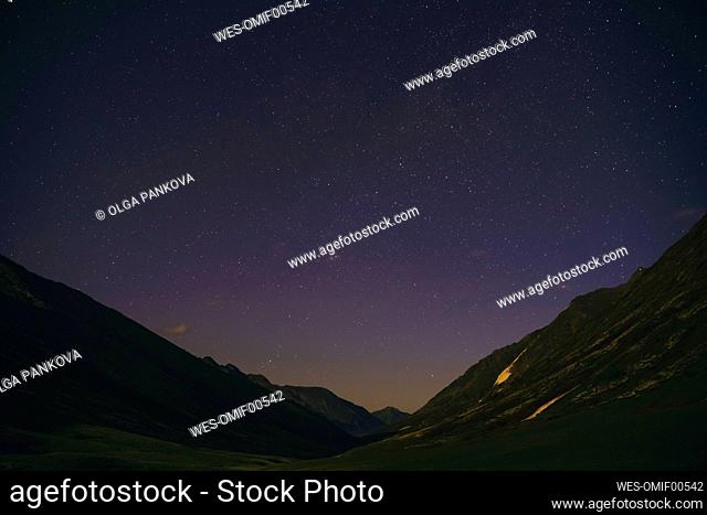 Starry sky over mountain valley at night