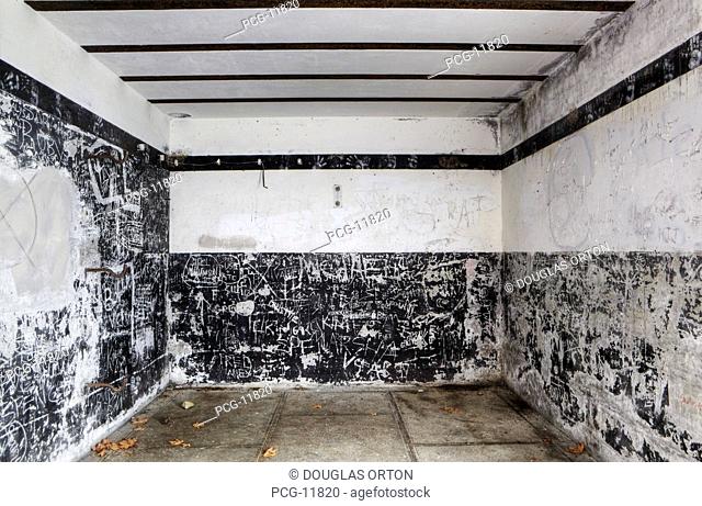 Concrete room with graffiti on a disused military base, Fort Flagler, a historic fortified place on the Puget Sound, founded in the 1890s