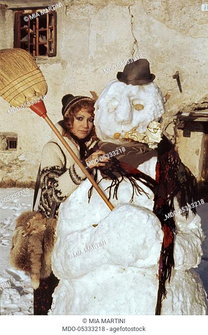 The singer Mia Martini (Domenica Rita Adriana Bertè) leaning against a snowman. Livigno, Italy. 1973