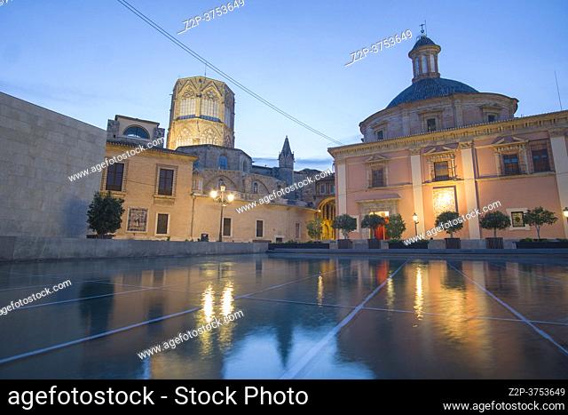 Valencia Spain on December 10, 2020: Basilica of the Virgin from Almoina museum by dusk with the pond reflections