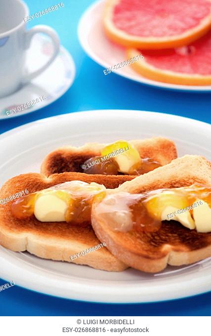 French toast and sliced orange fruit on blue tablecloth