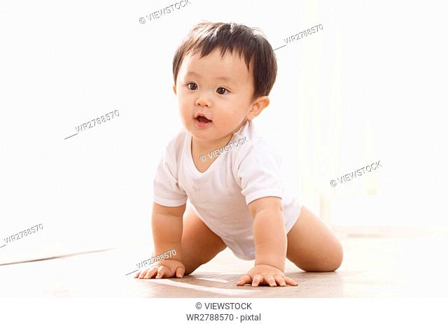 Baby crawling on floor