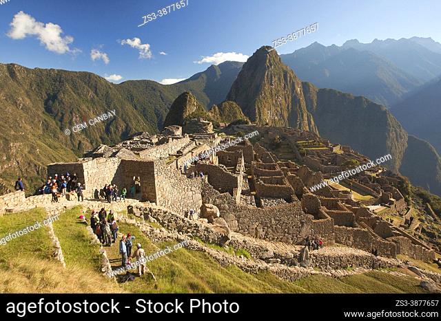 Visitors walking around the stone tempels at Machu Picchu Archaeological Site, Cusco Area, Peru, South America