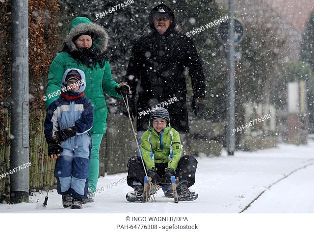 The Ebener family play with a sleigh on a street path in Ganderkesee, Germany, 03 January. After a mild December, the beginning of Januray is when Winter is...