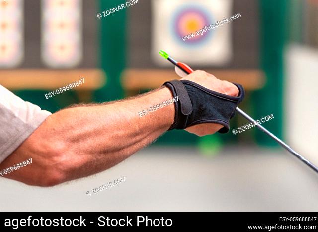 Archery. Archer exercise with the bow. Sport, recreation concept. Sportsman is preparing the arrow for the shot