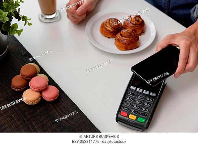 Customer making wireless or contactless payment using smartphone, nfc payment