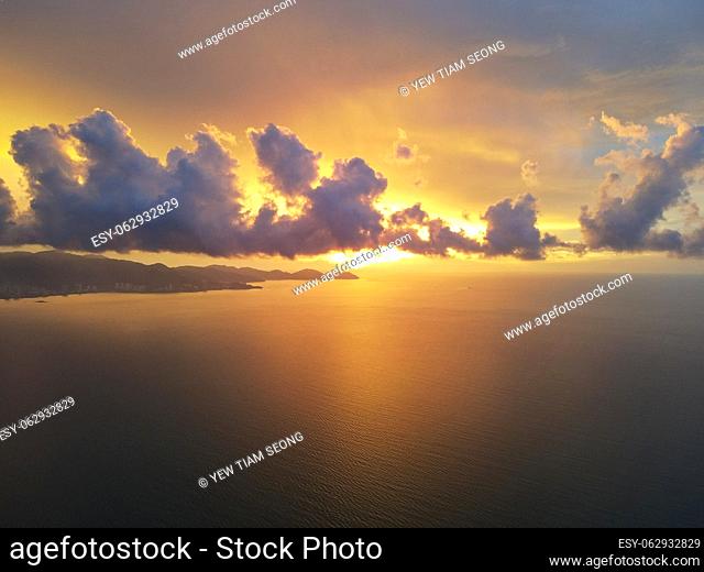 Dramatic orange color sky during sunset hour at sea. Aerial view