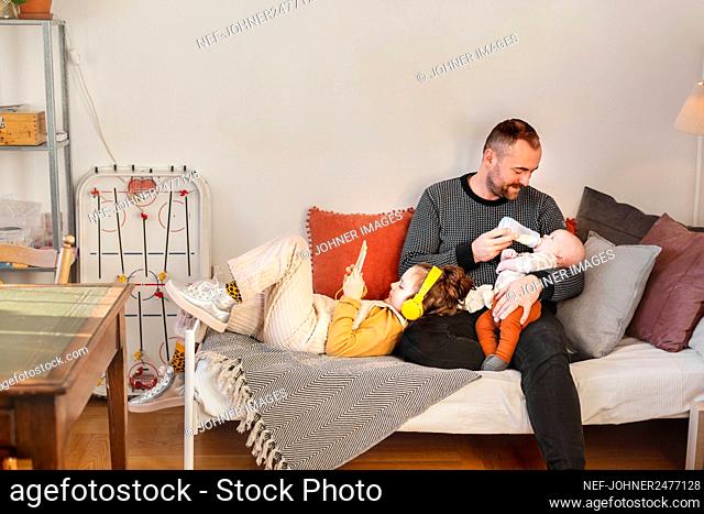 Father with children in living room