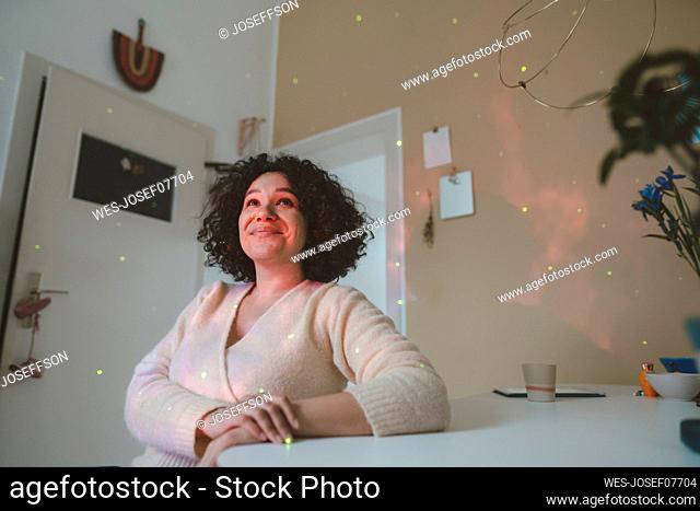 Smiling woman looking at astro light effects in room