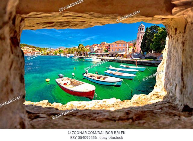 Turquoise waterfront of Cavtat view through stone window, Dalmatia, Croatia