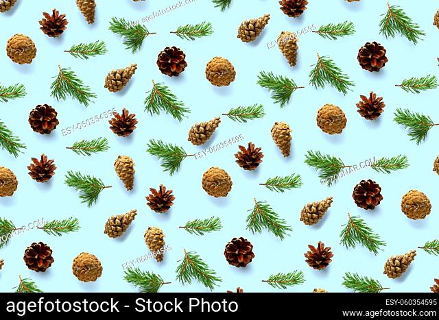 Creative Pine cone Christmas background on blue. Pine branches and cones. minimal creative cone arrangement pattern. flat lay, top view