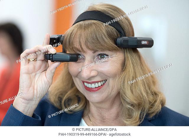 19 March 2019, Saxony, Dresden: Petra Köpping (SPD), integration minister of Saxony, wears augmented reality glasses (AR glasses) in a conference room of the...