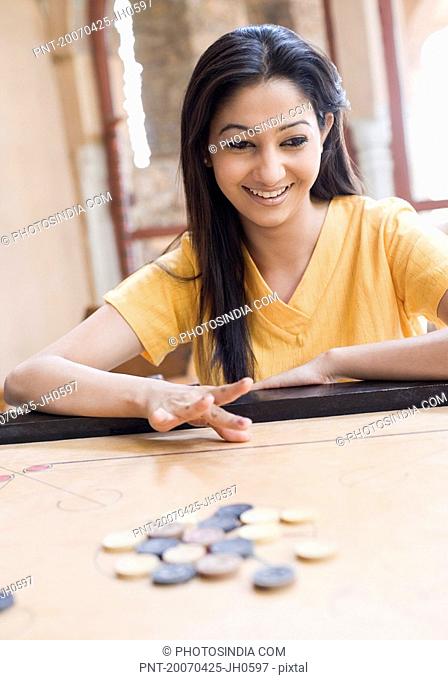 Close-up of a young woman playing carom