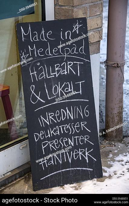 Sundsvall, Sweden A sign in front of a local delicatessen says in Swedish: ""Sustainable and local, crafts and presents. ""