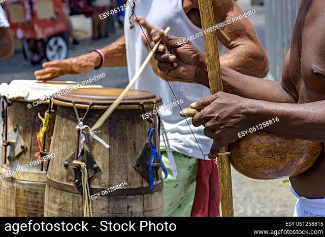 Brazilian musical instruments called berimbau and atabaque usually used during capoeira fight brought from africa and modified by the slaves in the streets of...