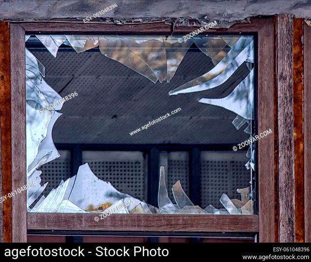 glass breakage, danger. big window with blue glass destruction