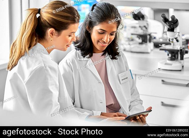 scientists with tablet pc working in laboratory