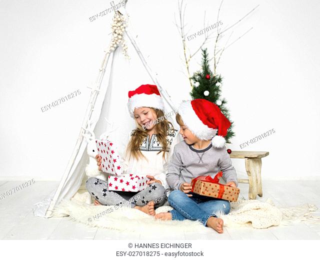 brother and sister with santa hat