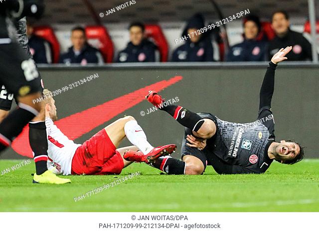 Mainz's Giulio Donati holds his crotch after an encounter with Leipzig's Konrad Laimer during the German Bundesliga match between RB Leipzig and FSV Mainz 05 at...