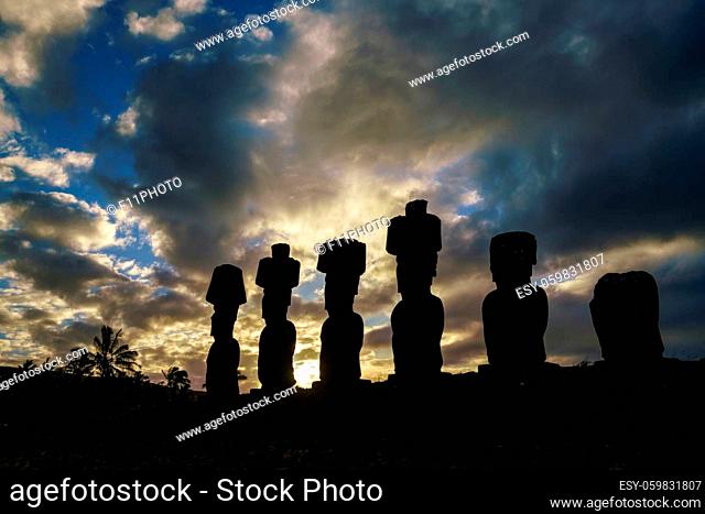 Silhouette shot of Moais at Anakena beach in Easter Island Chile sunset