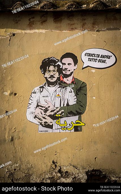 A view of a mural believed to be made by street artist Laika portraying Patrick George Zaky (L) wearing an inmate uniform and being embraced by Giulio Regeni...
