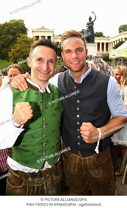 22 September 2019, Bavaria, Munich: Oktoberfest 2019, the kickboxing coach Mladen Steko (l) and the kickboxing world champion Sebastian Preuss present...