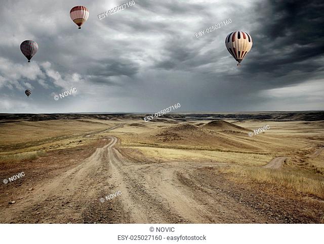 Air balloons flying over the country road