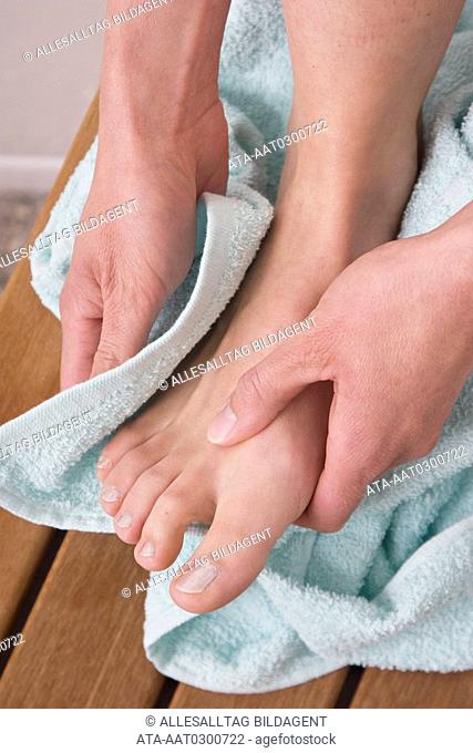 Woman towels her feet