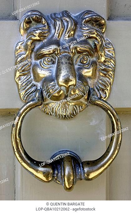 Polished brass door knocker on a house in Saffron Walden