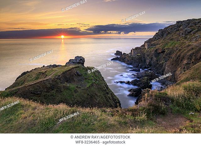 The setting sun captured in mid July from the clifftop above De Narrow Zawn at Botallack in Cornwall. . A long shutter speed was utilized to blur the movement...