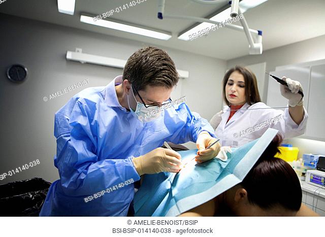 Reportage in a dermatology practice in Geneva, Switzerland. The dermatologist removes a cyst, helped by his assistant