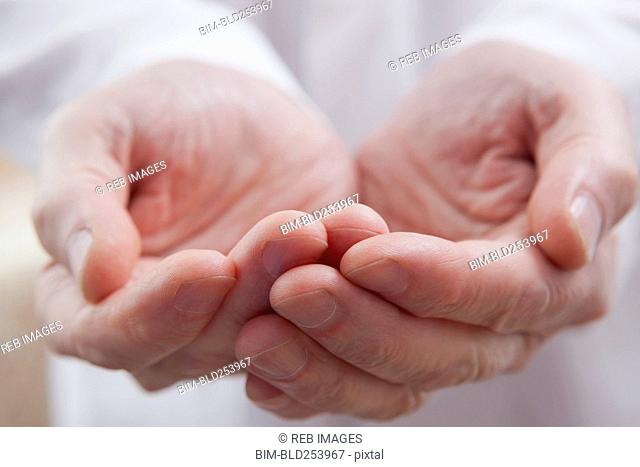 Cupped hands of Hispanic doctor