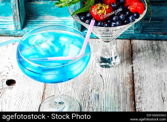 Alcohol in stylish blue color glass glass on long stalk