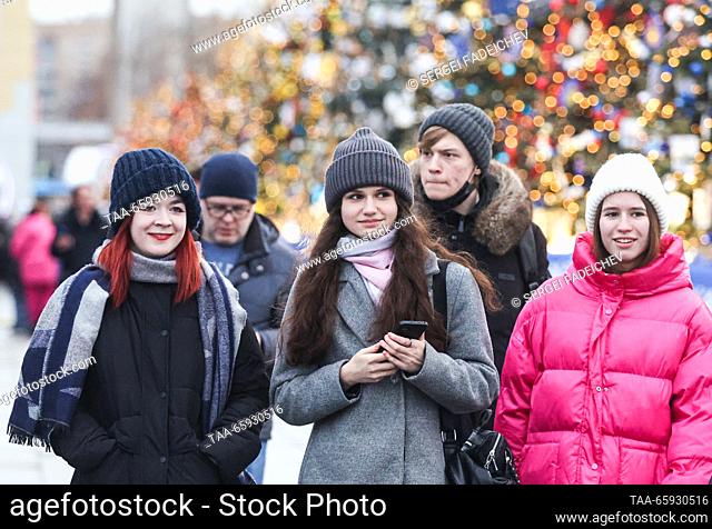 RUSSIA, MOSCOW - DECEMBER 20, 2023: People walk along the main alley of the VDNKh exhibition centre during the Russia Expo international exhibition and forum