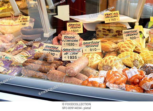Sausage and cheeses in a grocery store display window