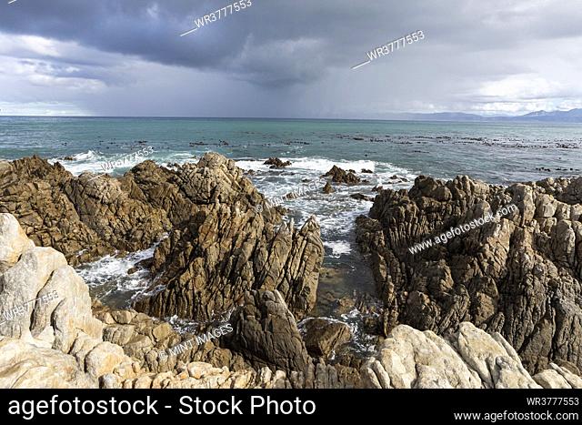 Rocky jagged coastline, eroded sandstone rock, view out to the ocean